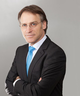A person wearing a suit and tie Description generated with very high confidence